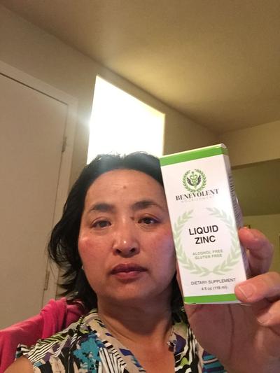 Woman holding box of liquid Zinc