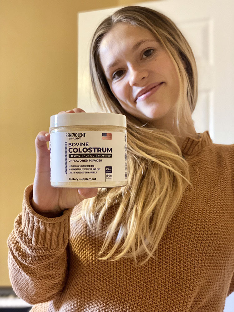 Woman holding Bovine Colostrum bottle