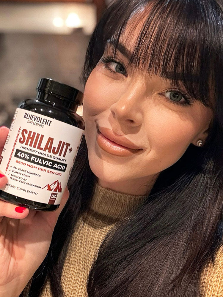 Woman holding Shilajit bottle